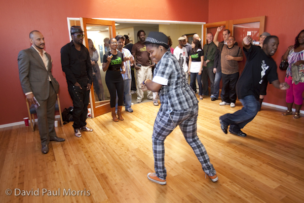 Front man will.i.am with the Black Eyed Peas watches participants dance at the Art In Action Youth Leadership Program facility