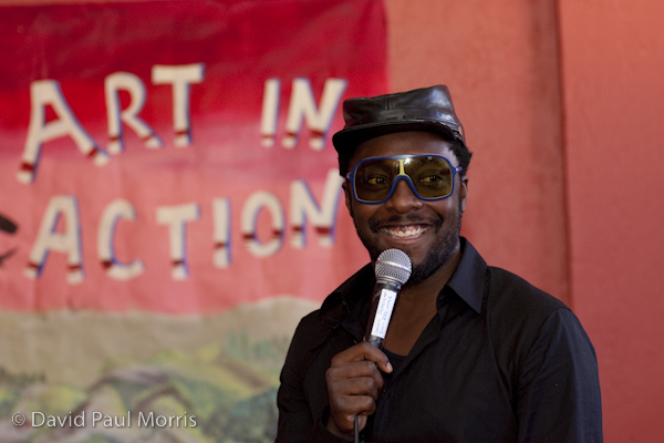 Front man will.i.am speaks to performers at the Art In Action Youth Leadership Program facility