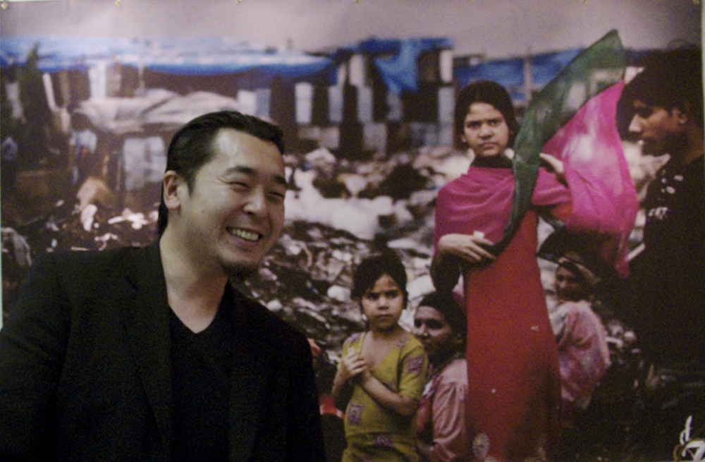 IMG_7978.CR2 Dai Sugano smiles as he stands in front of one of his images on display at the Exposure Gallery in San Francisco.