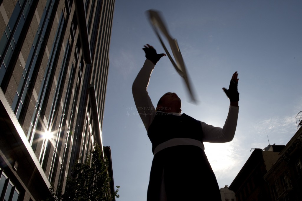 veterans Annalyn Austria, 15 and a student at Mercy High School practices throwing her rifle in the air before the start of the Veterans Day Parade.