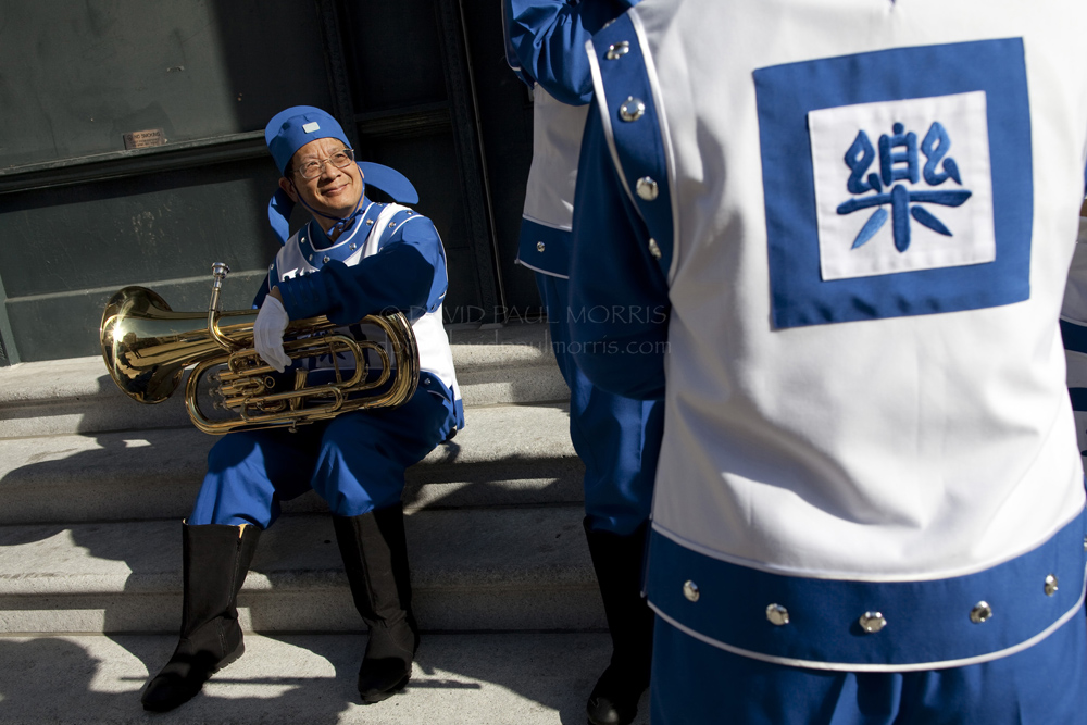 veterans Cliff Chen, 60 a member of the Falun Gong music band waits to start the Veterans Day Parade.