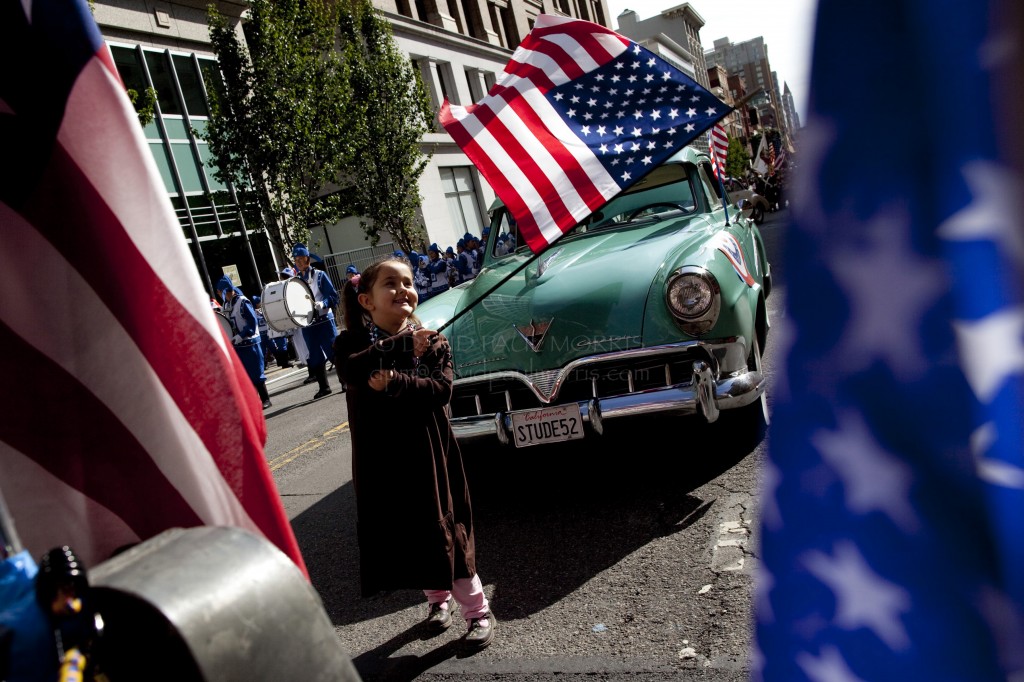 veterans Michelle Frisse, 5 of Antioch plays with a flag during the Veterans Day Parade.